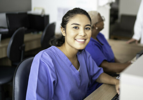 Portrait of secretary working at hospital reception